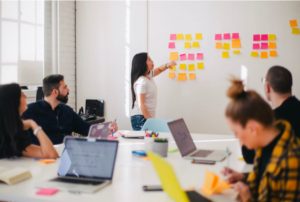 Lady working in a meeting with sticky notes